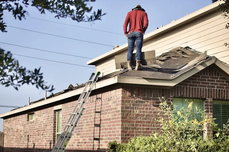 Professional roofer working on a residential roof in Aztec